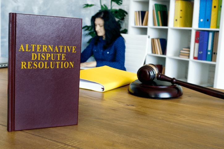 Business woman sitting in office, Book about alternative dispute resolution