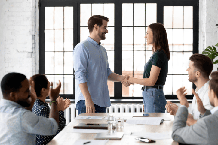 The Employee Incentives Program Ideas, 2 people shaking hands in a meeting