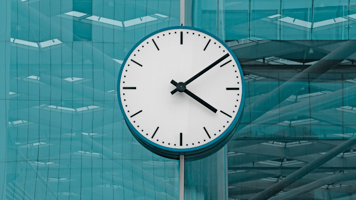 white clock on blue background symbolising padding hours