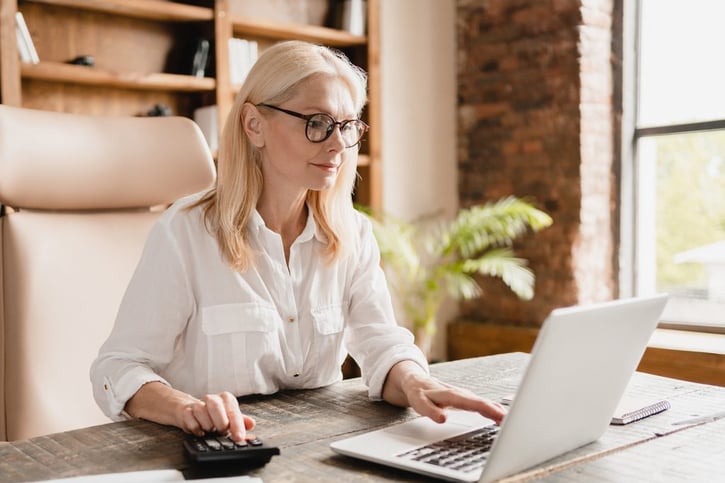 manager calculating pay mix using calculator
